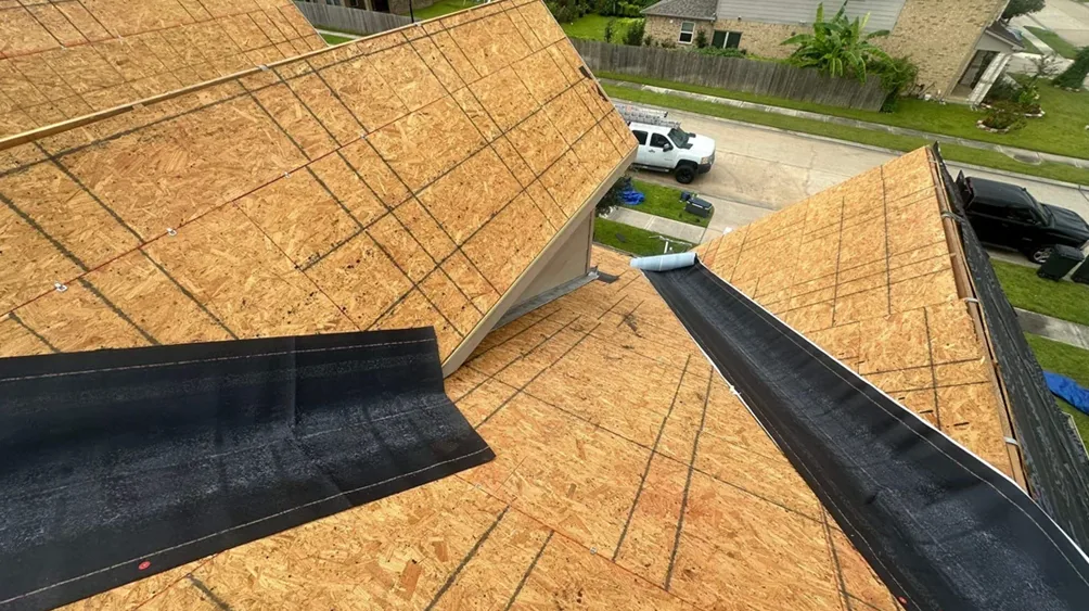 Betna crew installing underlayment over new decking at the roof valleys